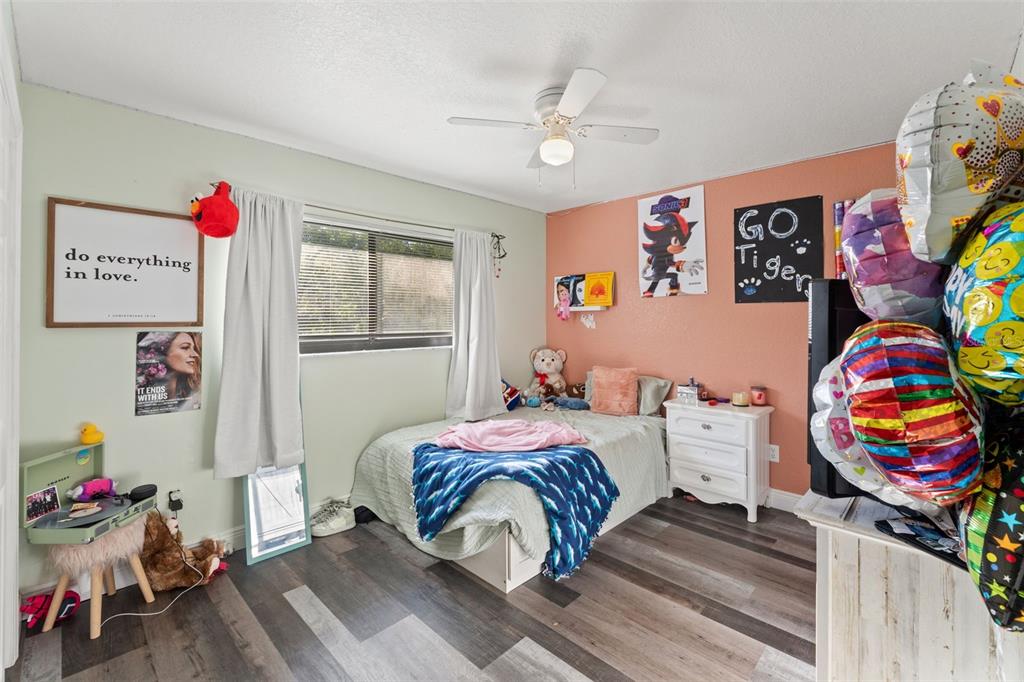 7180 Royal Oak Drive Spring Hill, FL 34607 - Photo 24 of 42 a bedroom with a bed and wooden floor