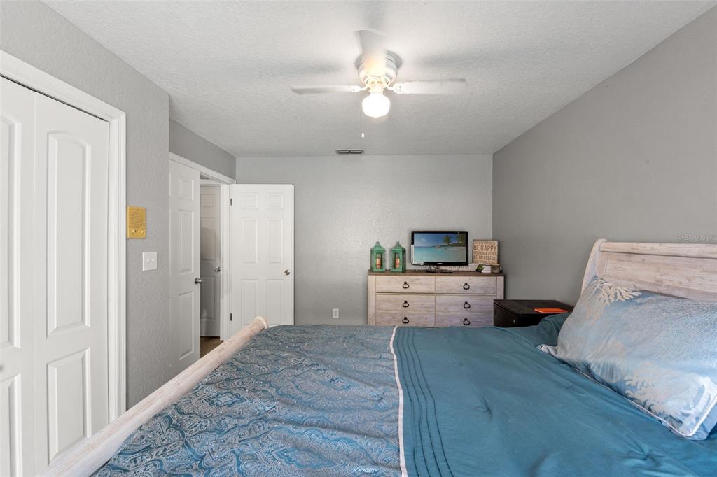 7180 Royal Oak Drive Spring Hill, FL 34607 - Photo 26 of 42 a room with a bed and a chandelier