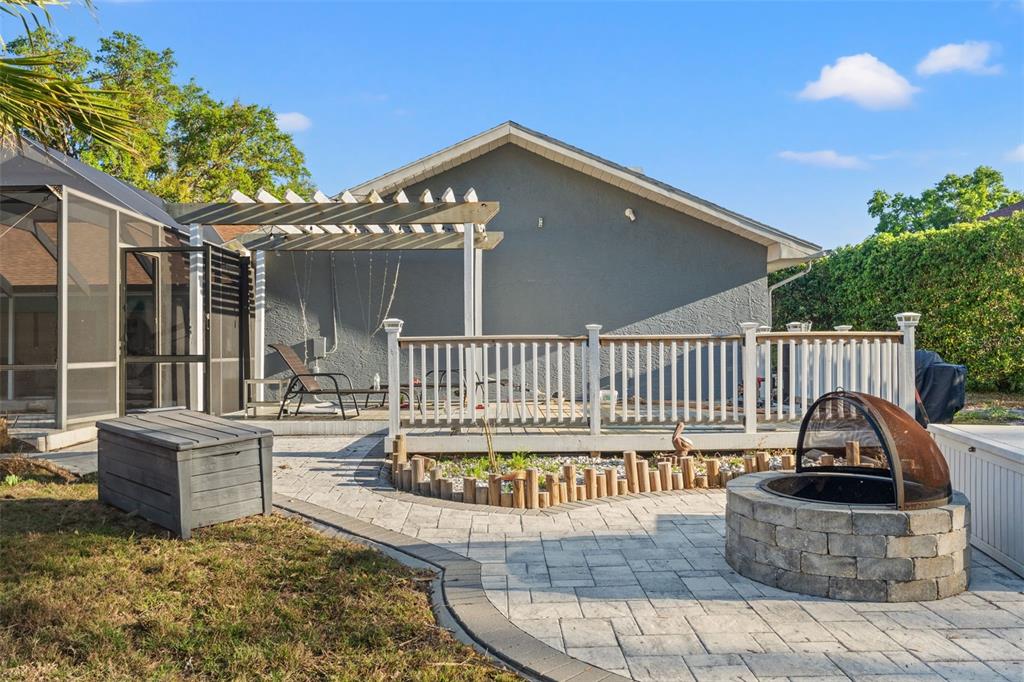 7180 Royal Oak Drive Spring Hill, FL 34607 - Photo 38 of 42 a view of a house with a wooden deck and furniture