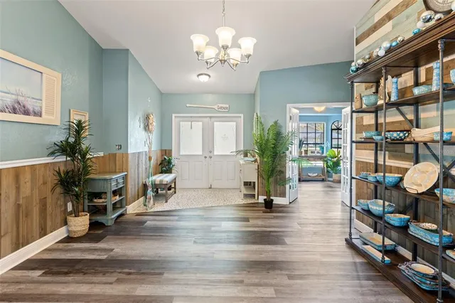 a living room with furniture and a chandelier