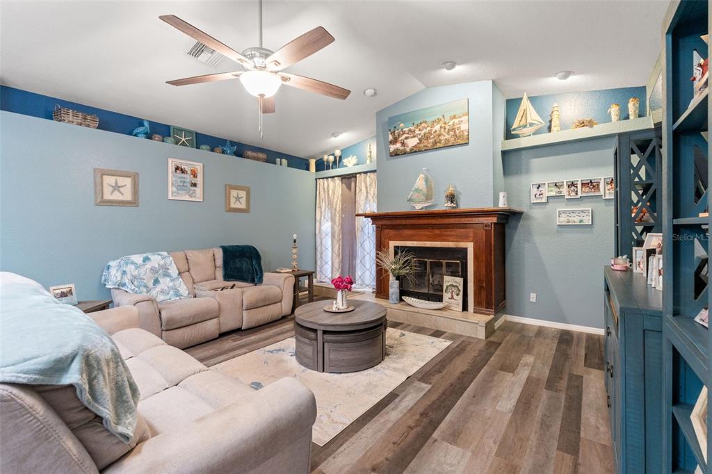 7180 Royal Oak Drive Spring Hill, FL 34607 - Photo 9 of 42 a living room with furniture and a fireplace