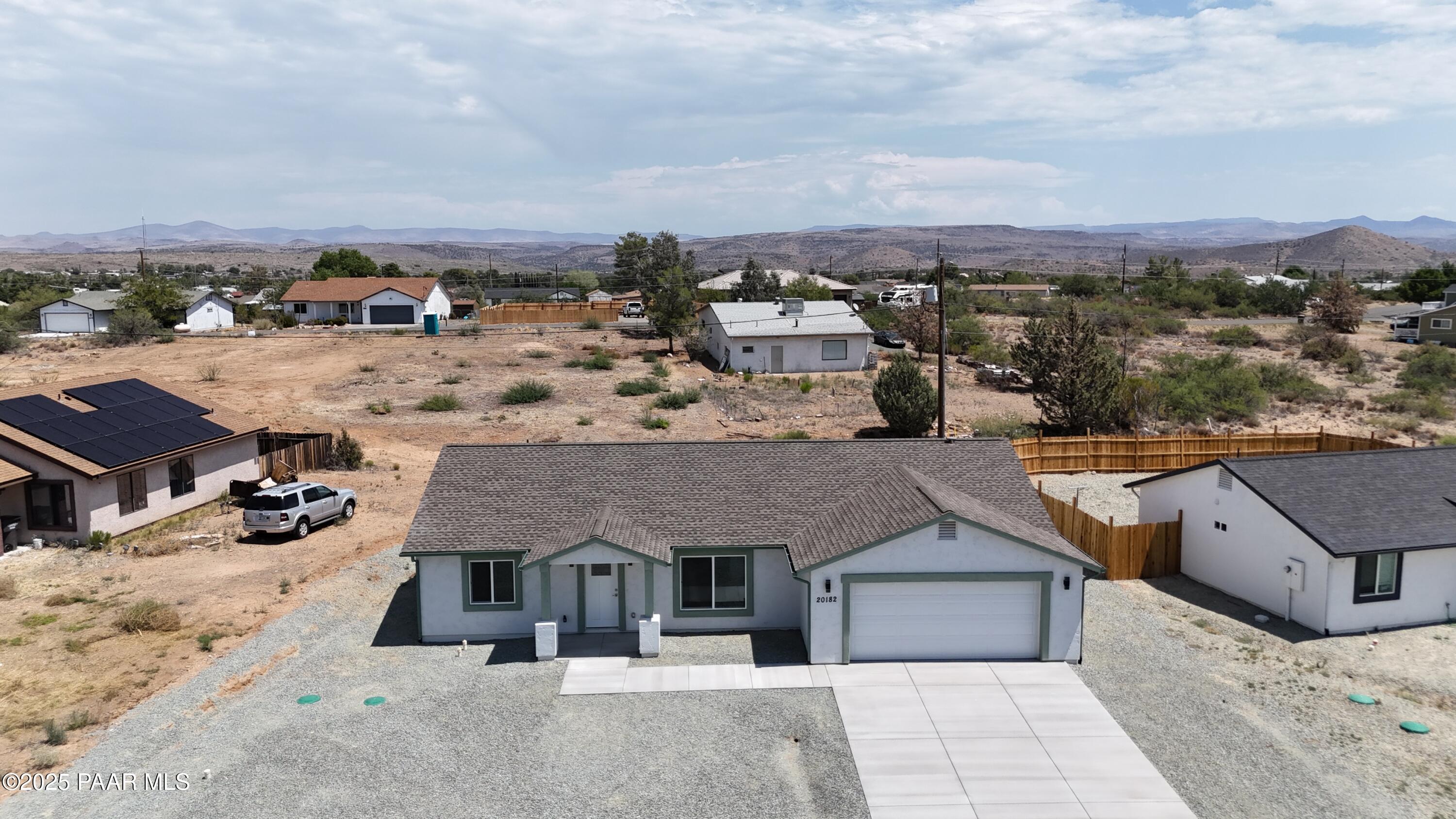 an aerial view of a house with a yard and large trees