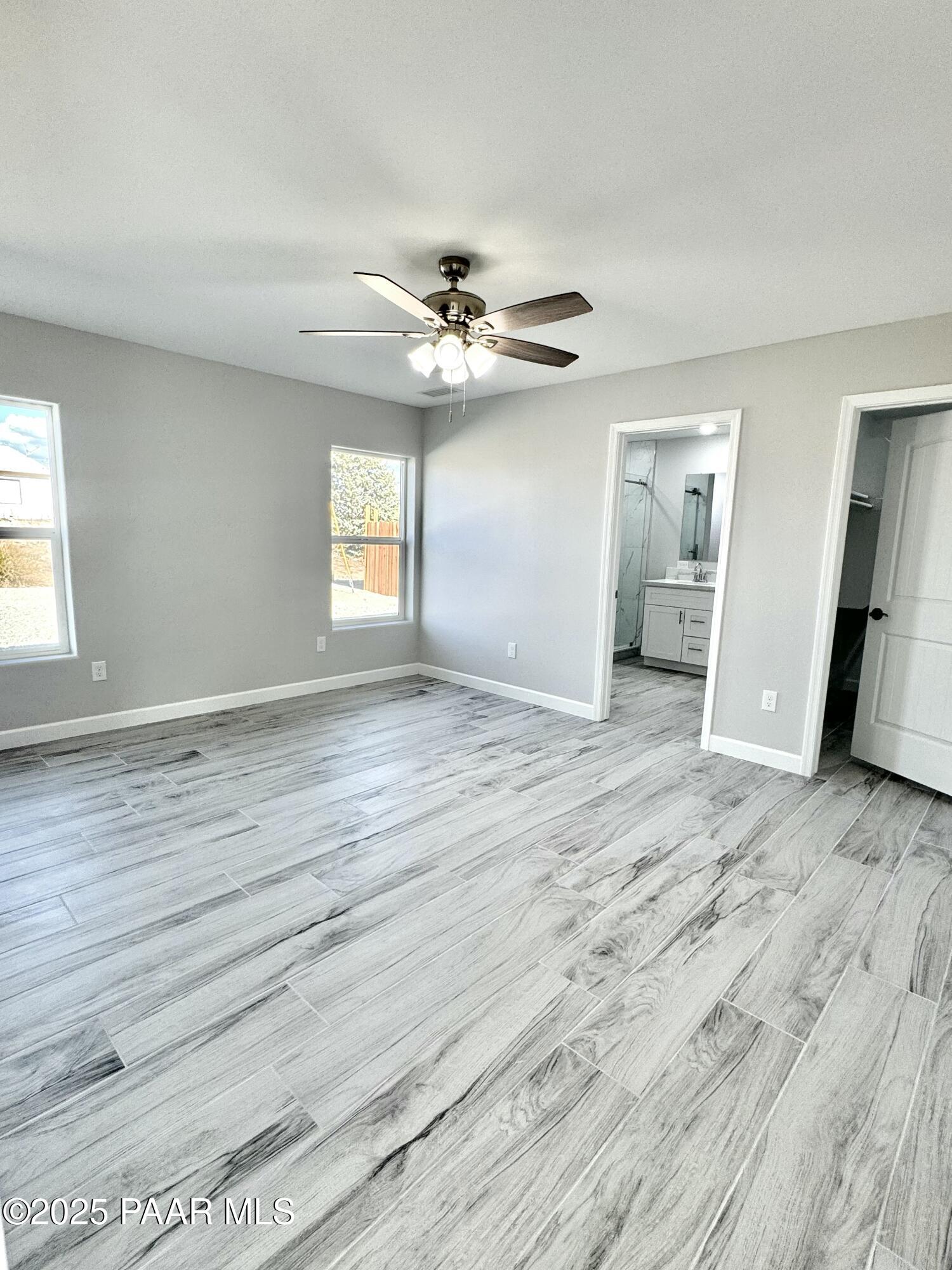 20182 East Mesa Verde Road Mayer, AZ 86333 - Photo 12 of 17 wooden floor in an empty room with a window