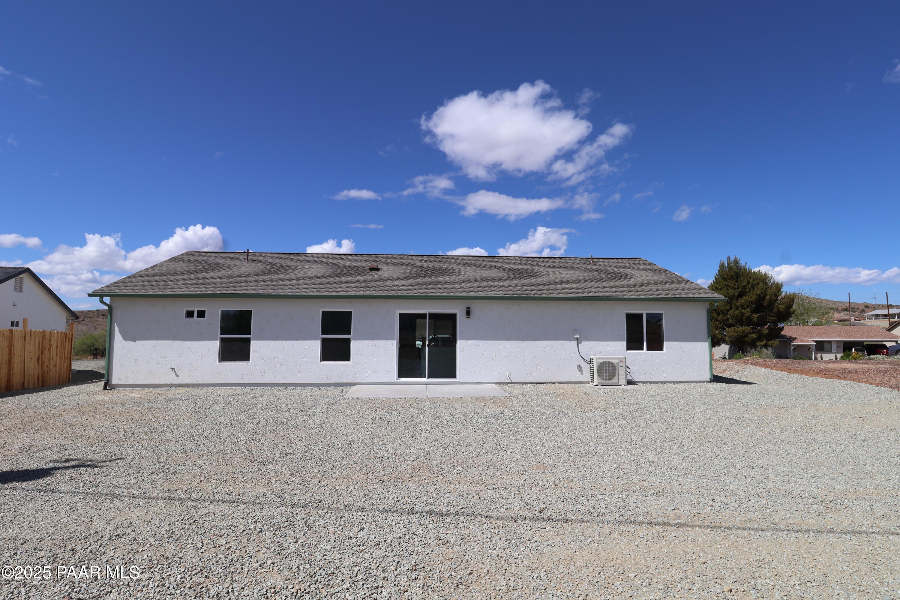 20182 East Mesa Verde Road Mayer, AZ 86333 - Photo 15 of 17 a front view of a house with a yard and garage