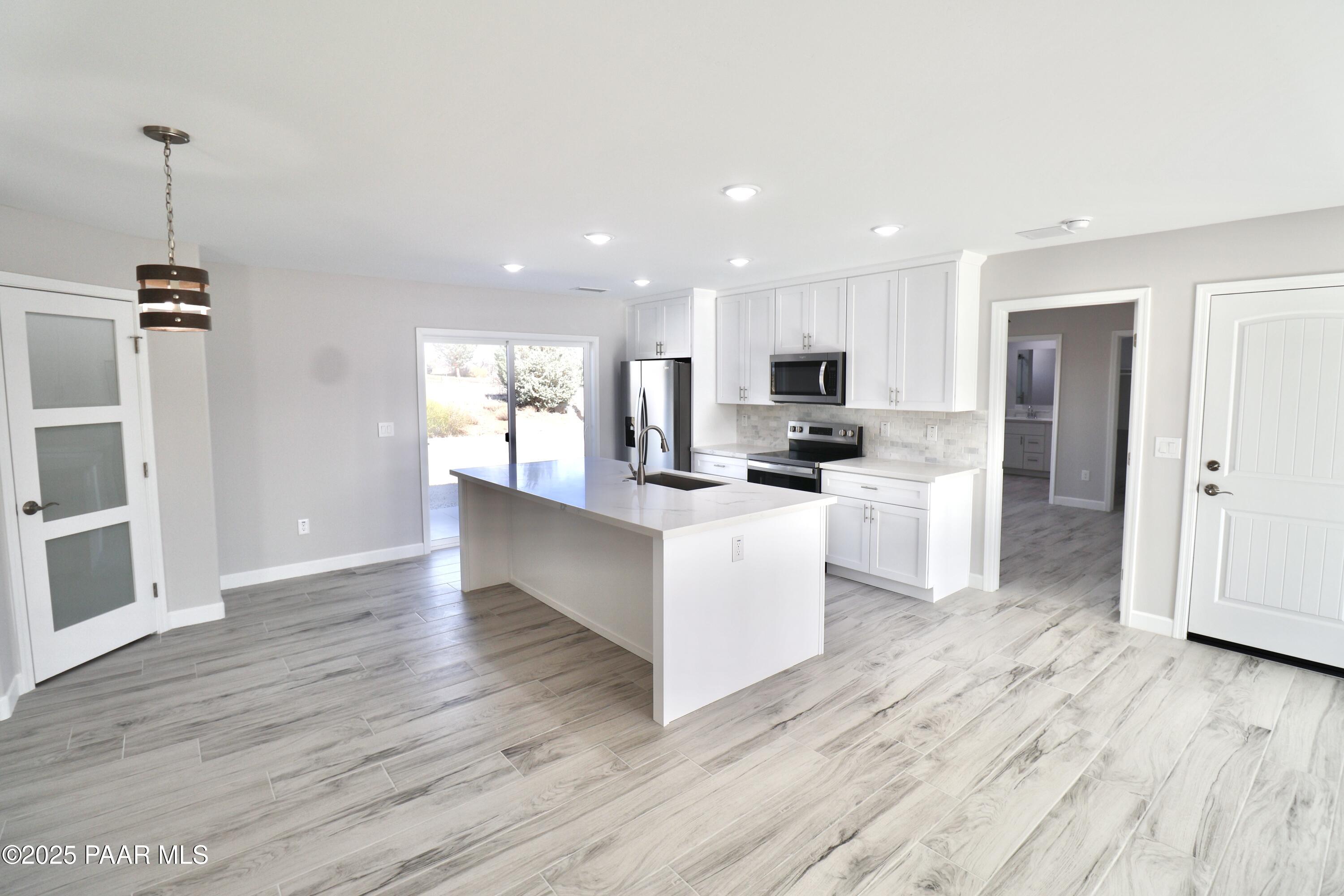 20182 East Mesa Verde Road Mayer, AZ 86333 - Photo 4 of 17 a view of kitchen with granite countertop cabinets and refrigerator