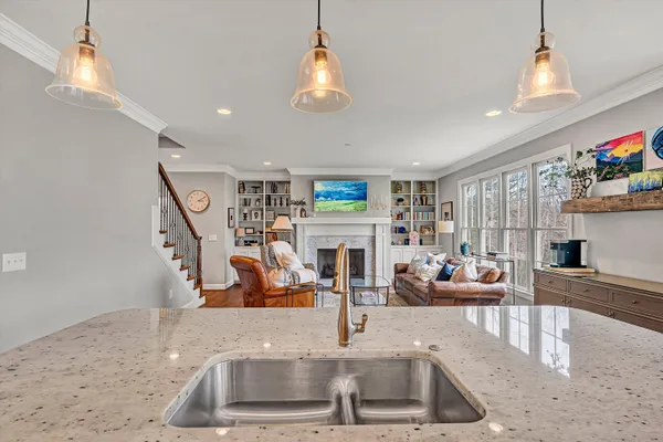 a kitchen with stainless steel appliances granite countertop a sink and a refrigerator
