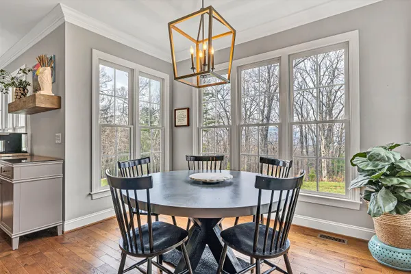a view of a dining room with furniture window and wooden floor