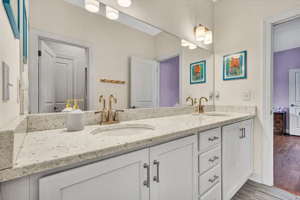 a bathroom with double sink and a mirror