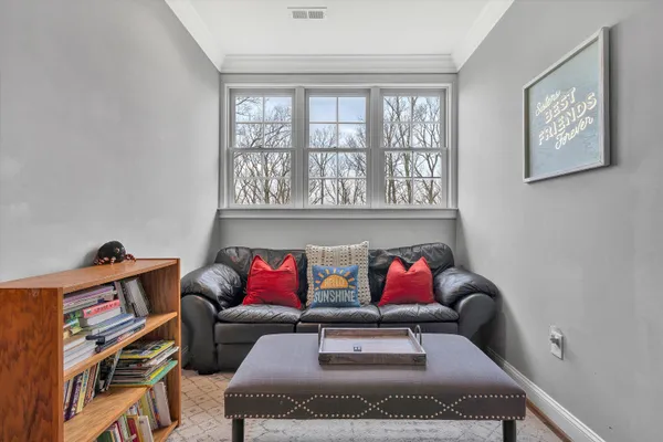 a living room with furniture and next to a window