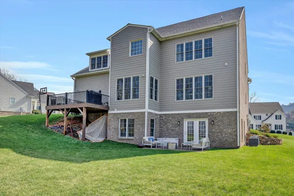 a view of a house with a yard and sitting area