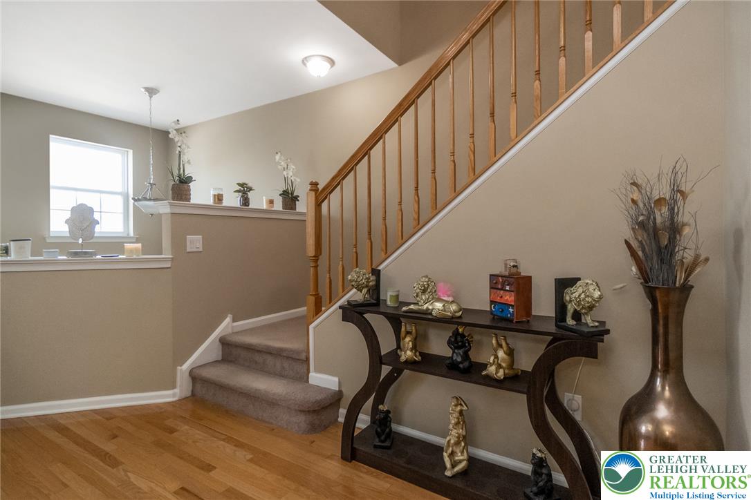 3566 Penfield Way Nazareth, PA 18064 - Photo 30 of 47 Natural wood flooring complements the staircase with light wood banisters, leading to upper levels.