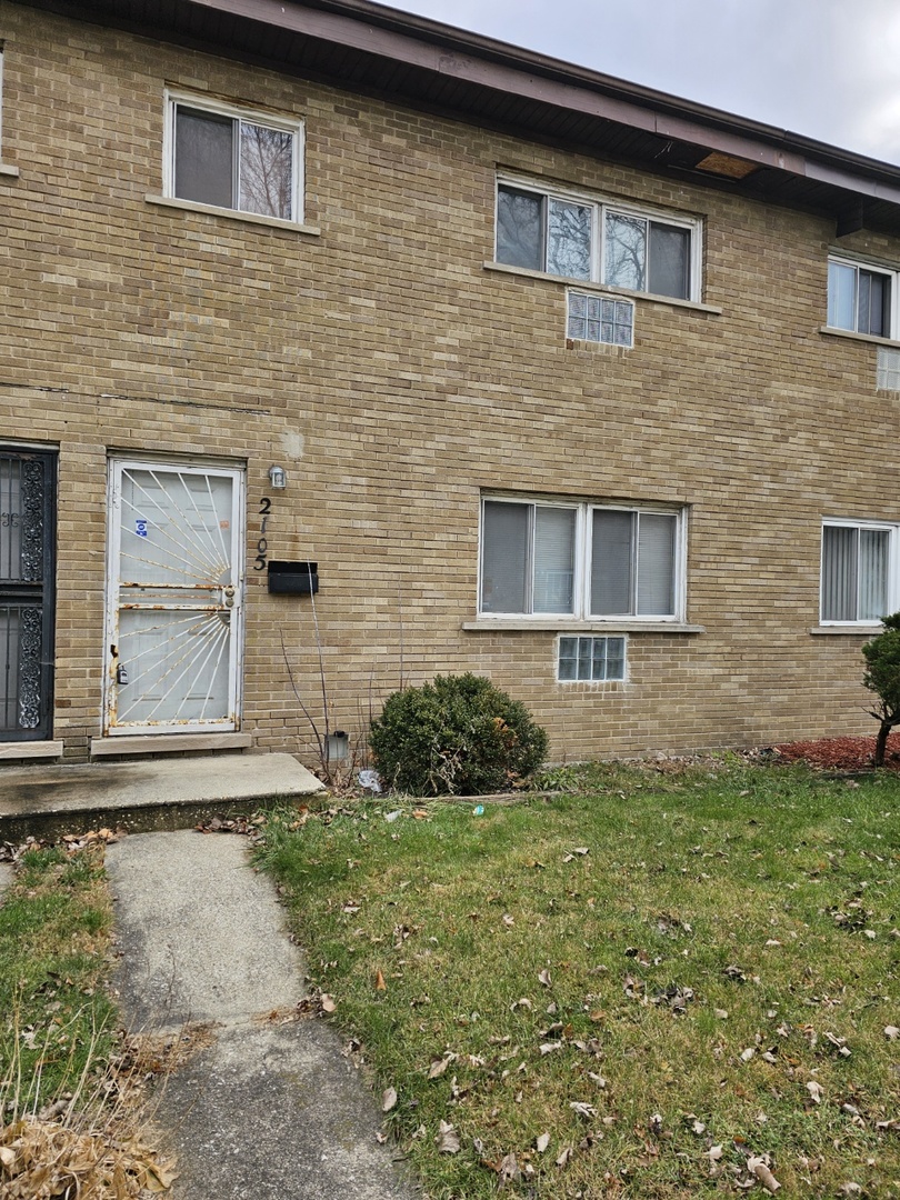 2105 171st Street Hazel Crest, IL 60429 - Photo 2 of 11 front view of a brick house with a yard