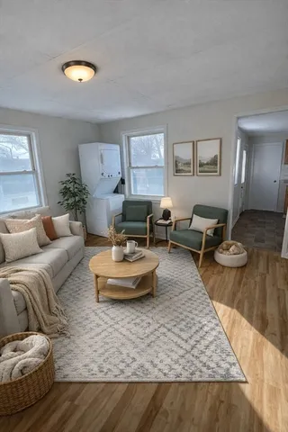 a living room with furniture and a wooden floor