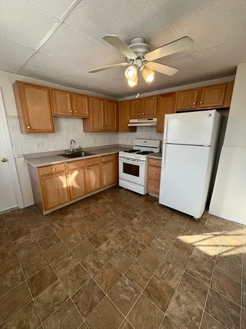 a kitchen with a sink stainless steel appliances and cabinets