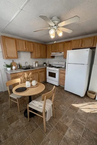 a kitchen with stainless steel appliances kitchen island granite countertop a sink and cabinets