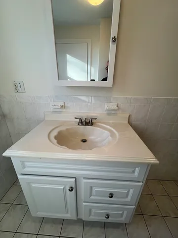 a bathroom with a sink toilet and window