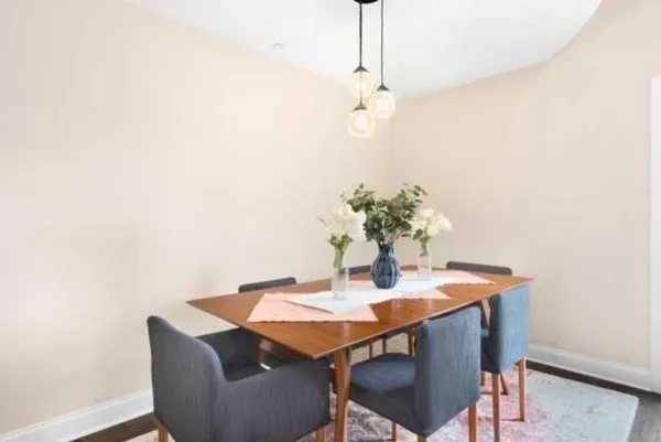 a dining room with furniture and chandelier