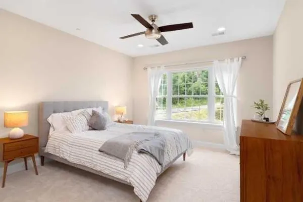 a bedroom with a bed and a window
