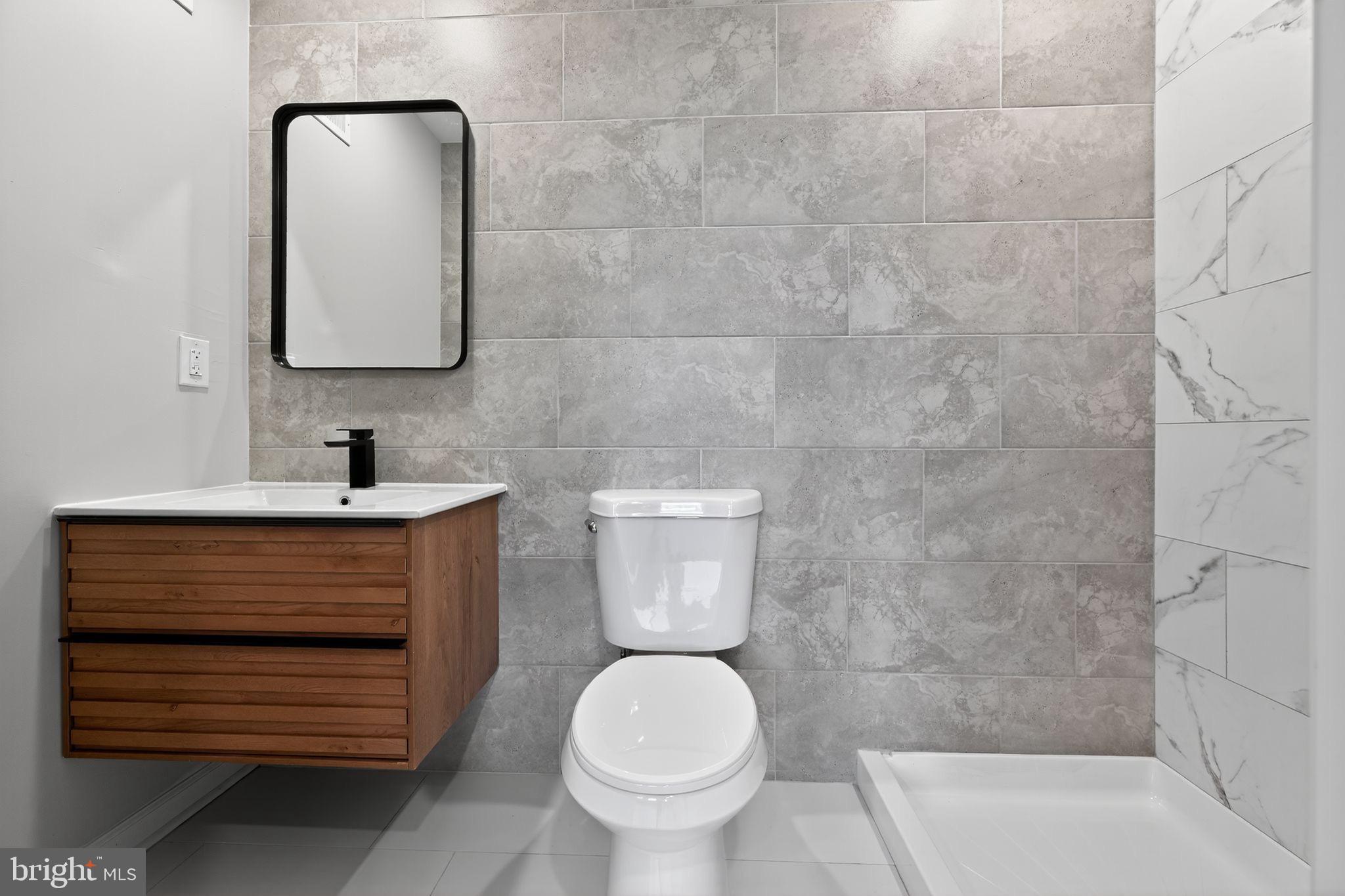 6019 Wharton Street Philadelphia, PA 19143 - Photo 19 of 30 Sleek modern bathroom with elegant finishes.