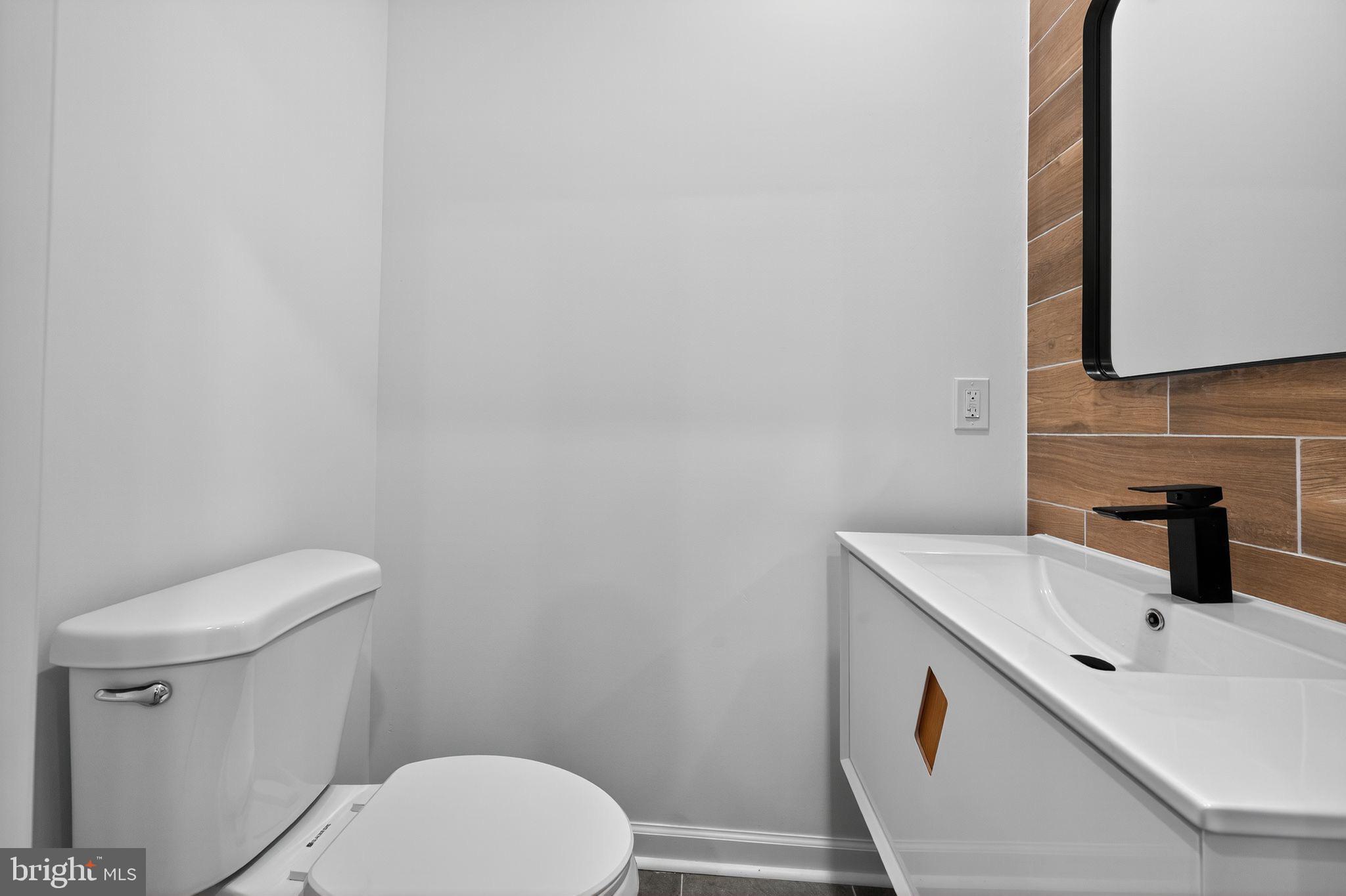 6019 Wharton Street Philadelphia, PA 19143 - Photo 21 of 30 Sleek modern bathroom with warm accents.