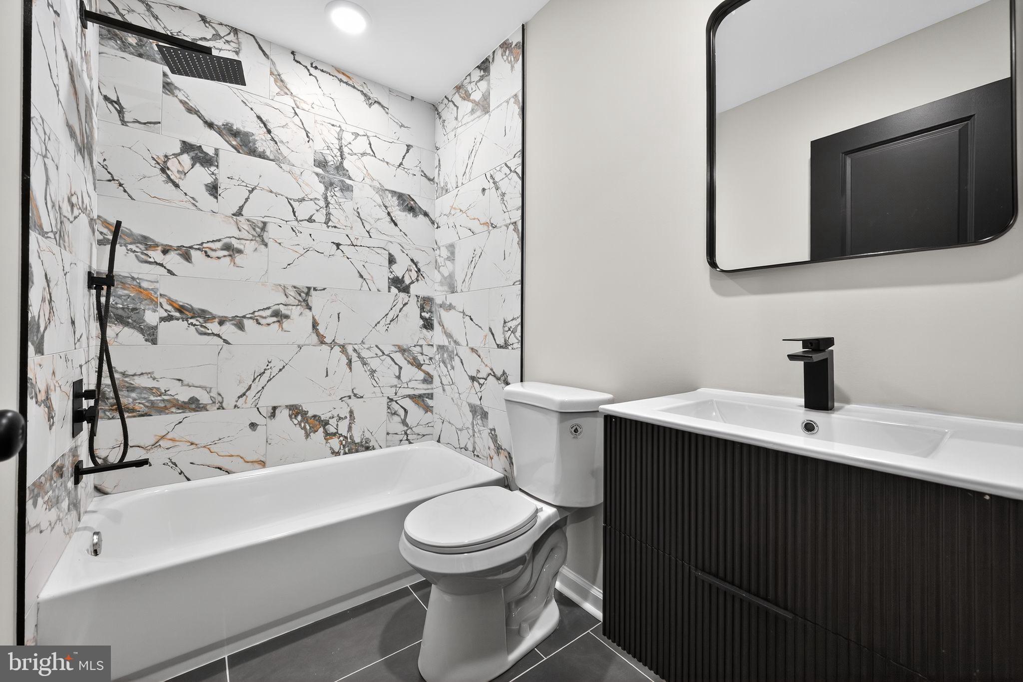 6019 Wharton Street Philadelphia, PA 19143 - Photo 22 of 30 Sleek modern bathroom with elegant marble accents.