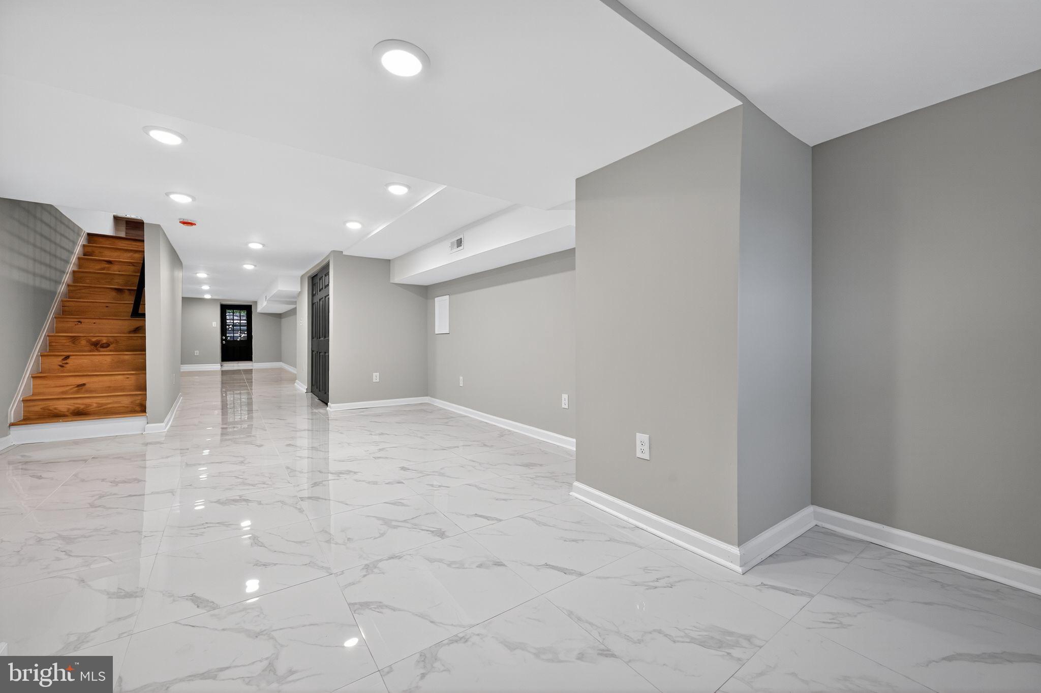 6019 Wharton Street Philadelphia, PA 19143 - Photo 23 of 30 Spacious, modern basement with sleek finishes.