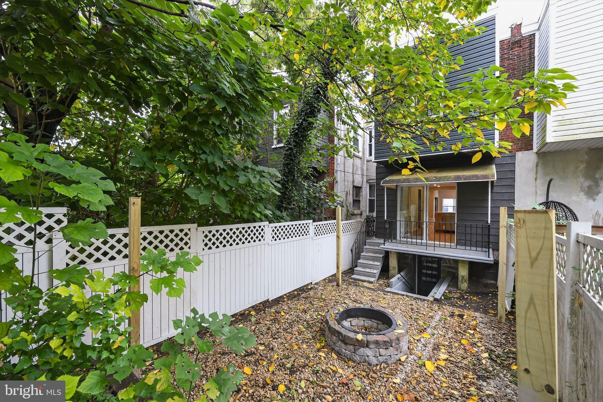 6019 Wharton Street Philadelphia, PA 19143 - Photo 26 of 30 Charming backyard oasis with fire pit.