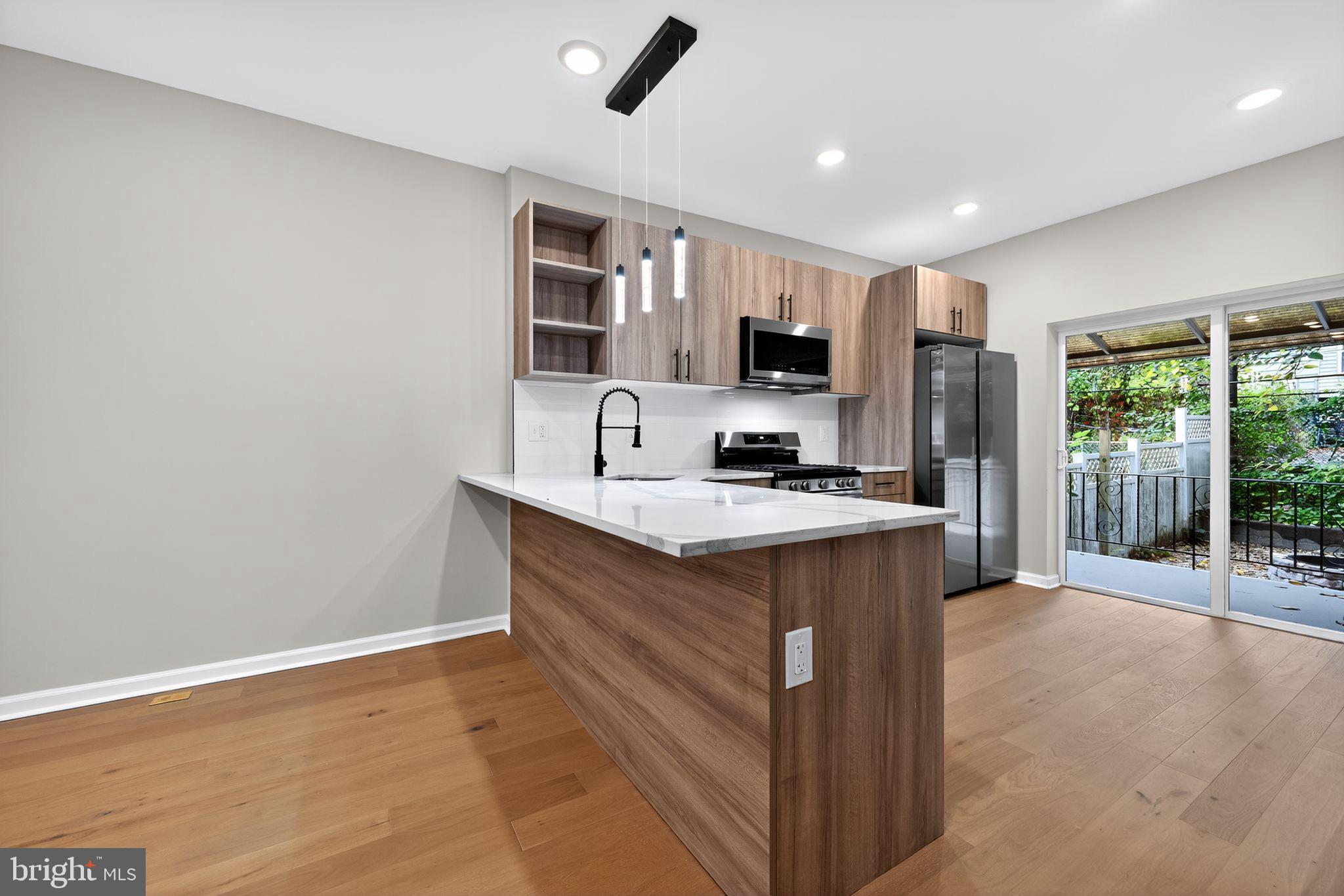6019 Wharton Street Philadelphia, PA 19143 - Photo 10 of 30 Modern kitchen with sleek finishes and light.