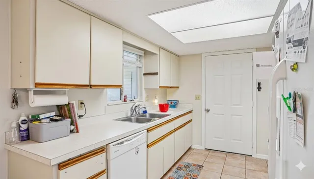 a kitchen with stainless steel appliances a refrigerator sink and cabinets