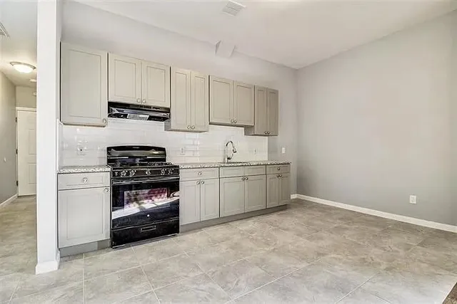 a kitchen with stainless steel appliances a refrigerator sink and cabinets