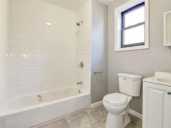 a bathroom with a toilet and bathtub