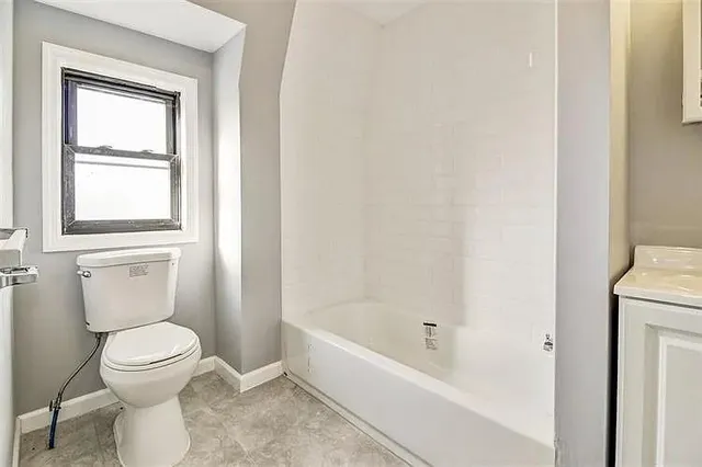 a bathroom with a toilet and a bathtub