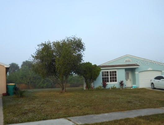 505 Ricold Terrace Port Charlotte, FL 33954 - Photo 2 of 3 a front view of a house with a garden