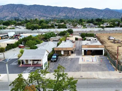 an aerial view of residential houses and outdoor space
