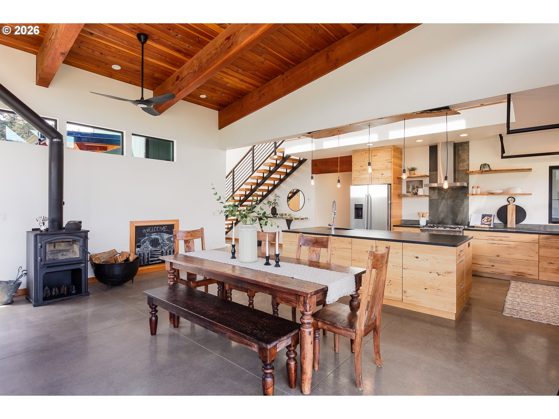 85535 Lancer Lane Eugene, OR 97405 - Photo 13 of 45 a living room with furniture a flat screen tv and kitchen view