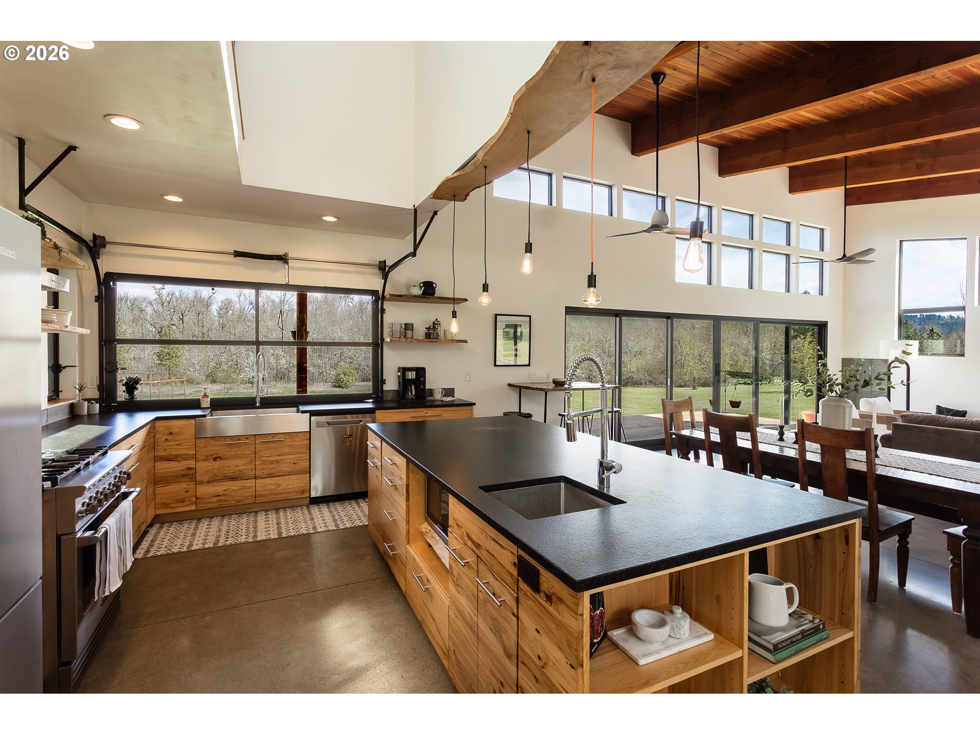 85535 Lancer Lane Eugene, OR 97405 - Photo 10 of 45 a kitchen with stainless steel appliances granite countertop a sink a counter space and a view of living room
