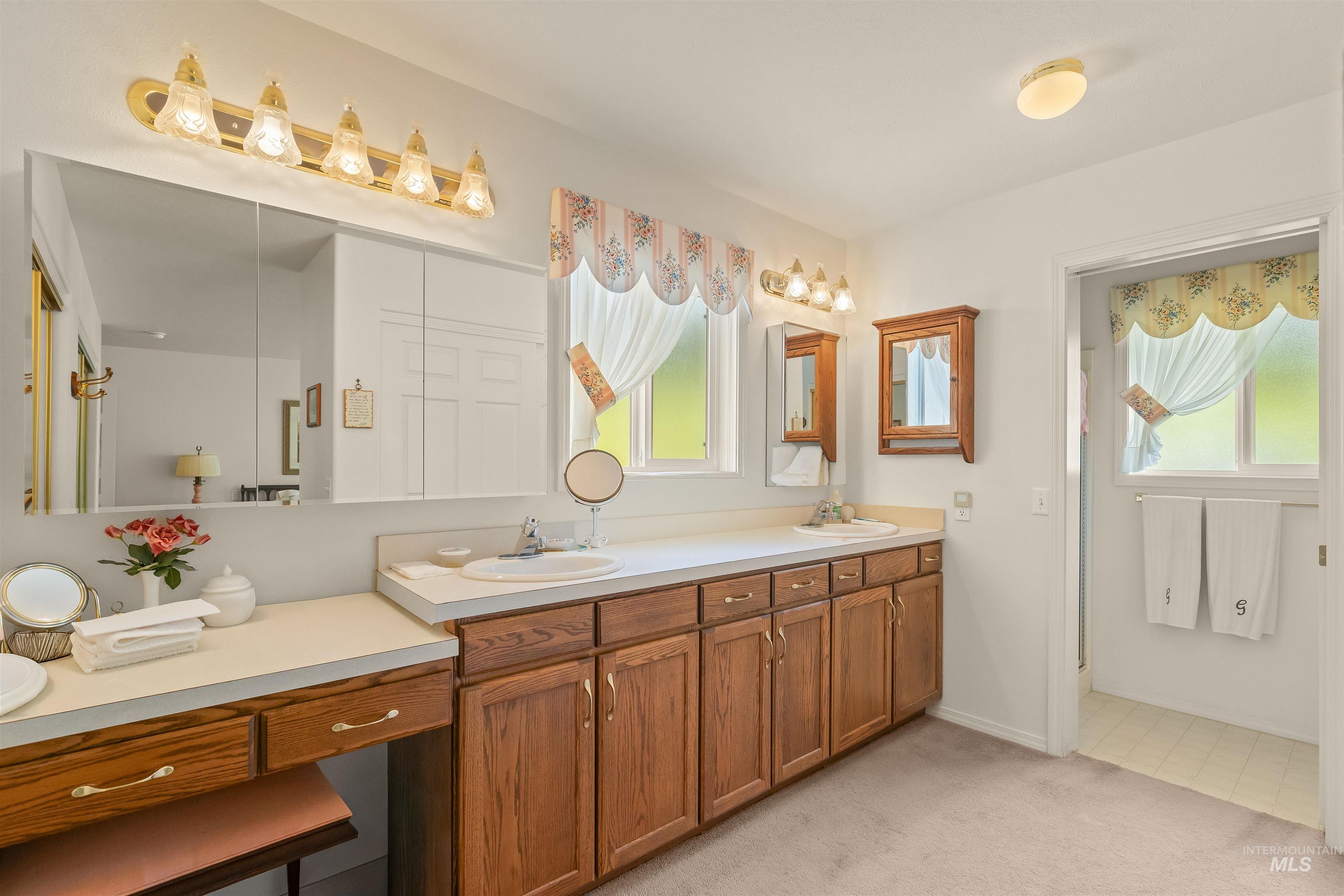 743 Wall Crk Road Stites, ID 83552 - Photo 43 of 48 Dual vanity with ample countertop space, extensive wood cabinetry, and an integrated vanity area