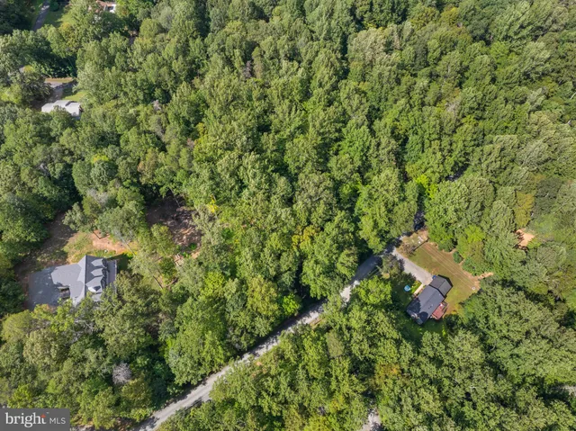 a backyard of a house with a yard and outdoor seating