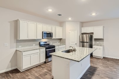 709 Iron Brg Road Georgetown, TX 78626 - Photo 4 of 11 Culinary delights await in this bright kitchen, complete with a functional island and gleaming appliances.
