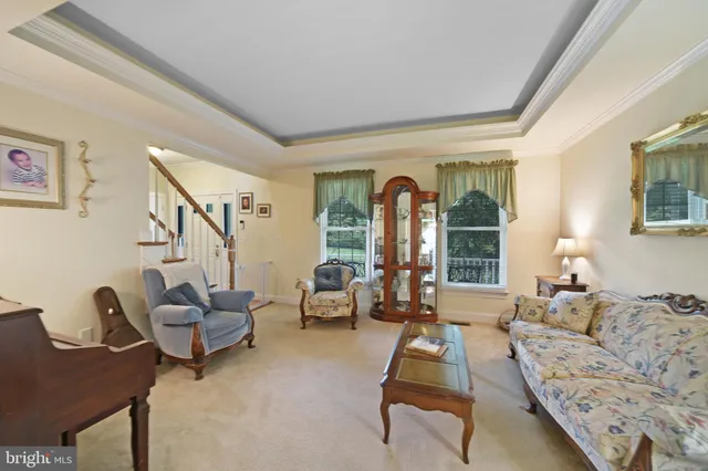 a living room with furniture and a piano