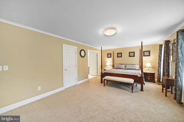 a bedroom with furniture and a closet