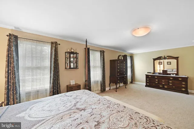 a spacious bathroom with a double vanity sink mirror and a bathtub