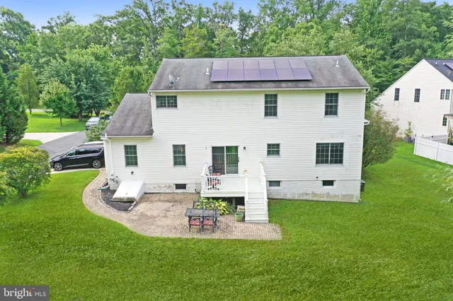 a view of house with backyard
