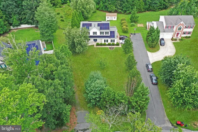 an aerial view of a house with outdoor space pool seating area and yard