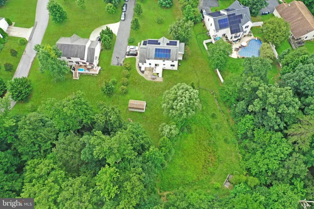 an aerial view of a house with a yard basket ball court and outdoor seating