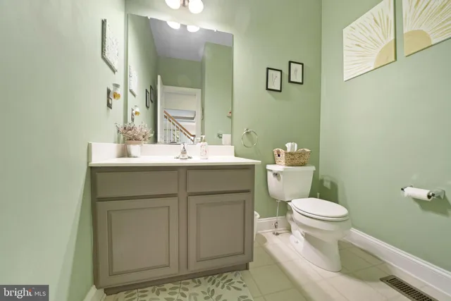 a bathroom with a sink toilet and a mirror