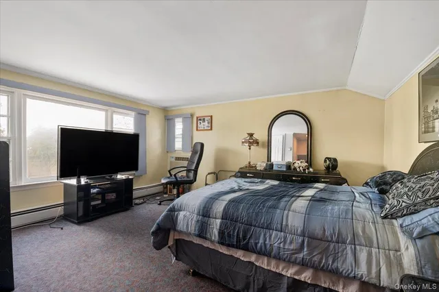 a bedroom with bed and a flat screen tv