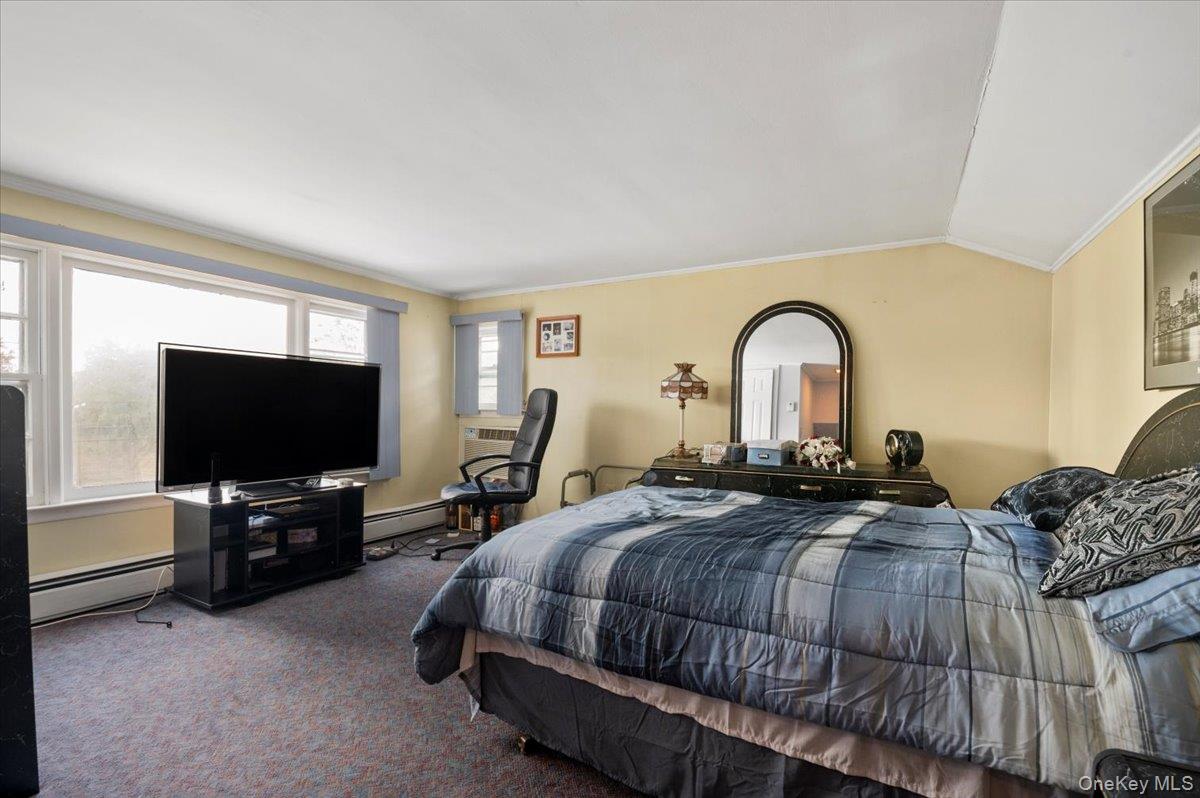 26 Bradford Lane Bethpage, NY 11714 - Photo 12 of 24 a bedroom with bed and a flat screen tv