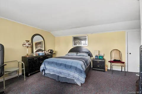 a bedroom with bed a lamp and window