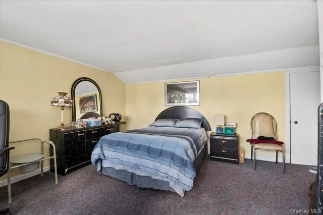 a bedroom with bed a lamp and window